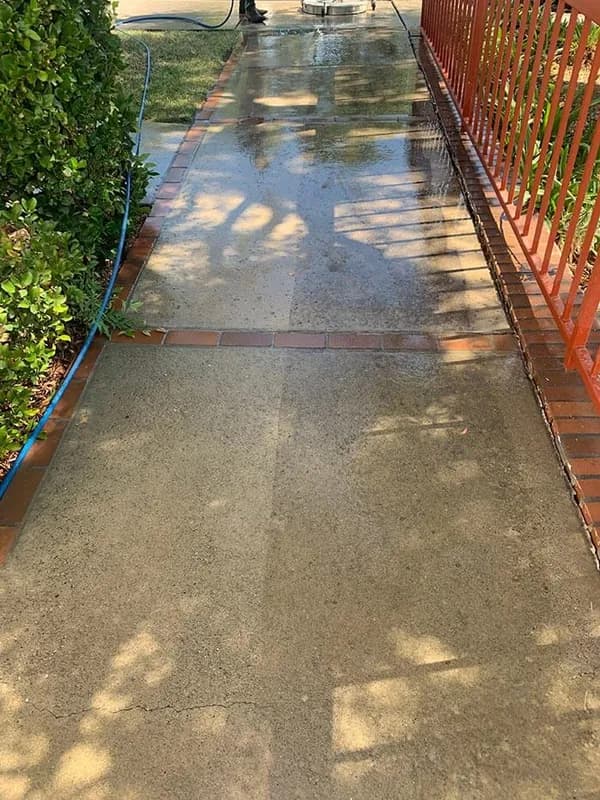 Long residential driveway part way through a pressure wash